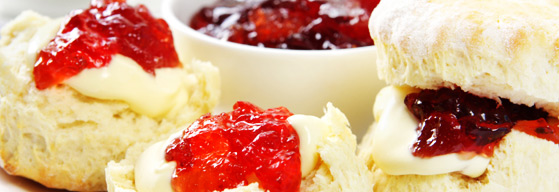 Strawberry jam and cream on thick scones